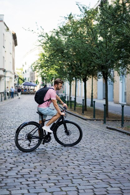 Young sports man on a bicycle in a European city. Sports in urban environments.