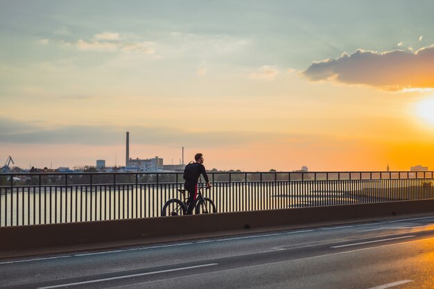 Young sports man on a bicycle in a European city. Sports in urban environments.