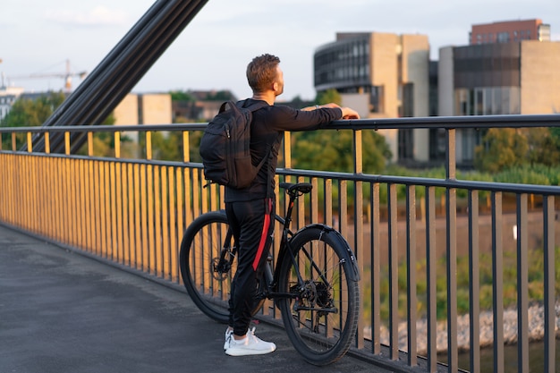 Young sports man on a bicycle in a European city. Sports in urban environments.