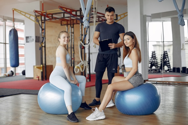 Young sports people training in a morning gym