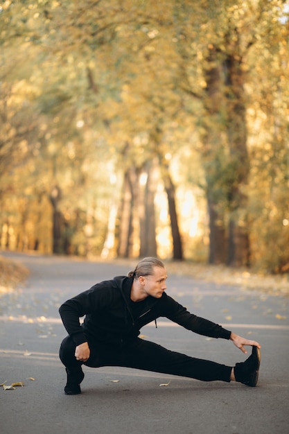 Young sportsman exercising in park