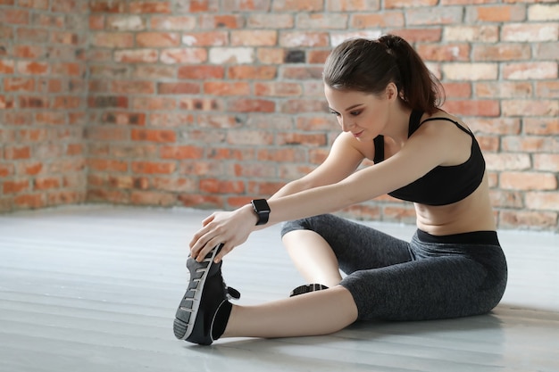 Young sportswoman stretching