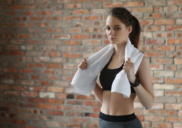 Young sportswoman with towel