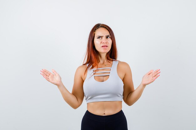 Young sporty woman being confused