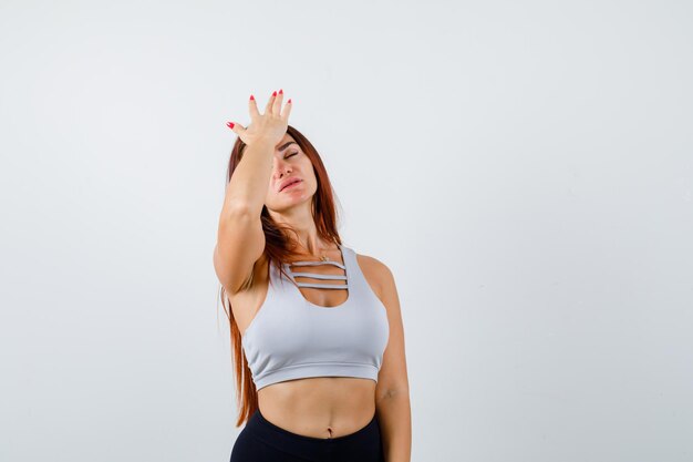 Young sporty woman in a gray top