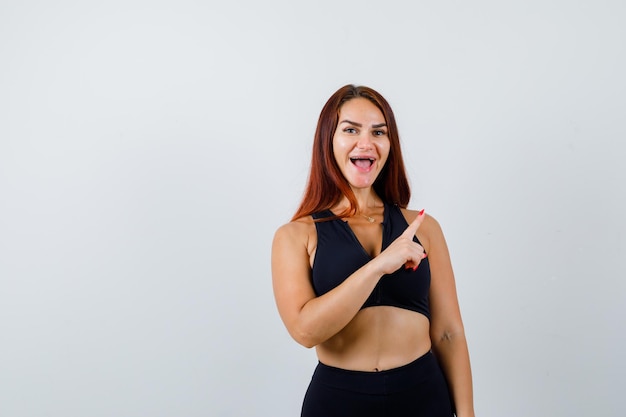 Young sporty woman with long hair in a black top