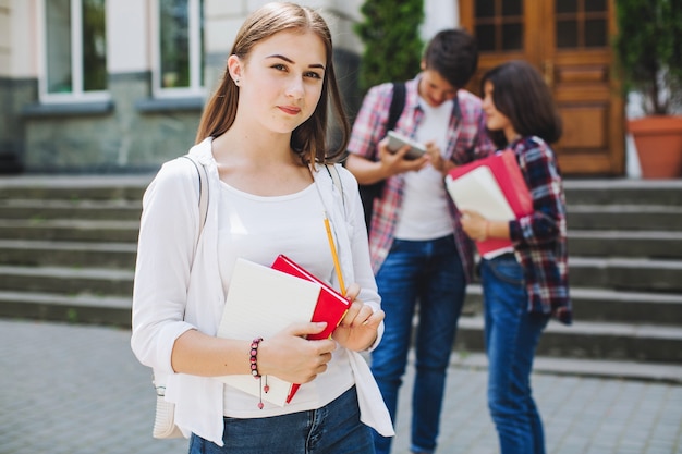 Young student posing near university