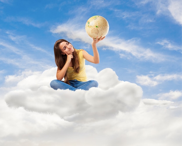 Free photo young student woman looking her world globe sitting on a cloud