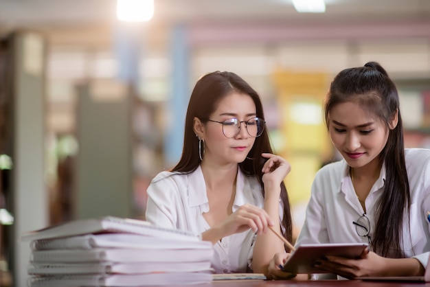  Young students learning, library bookshelves