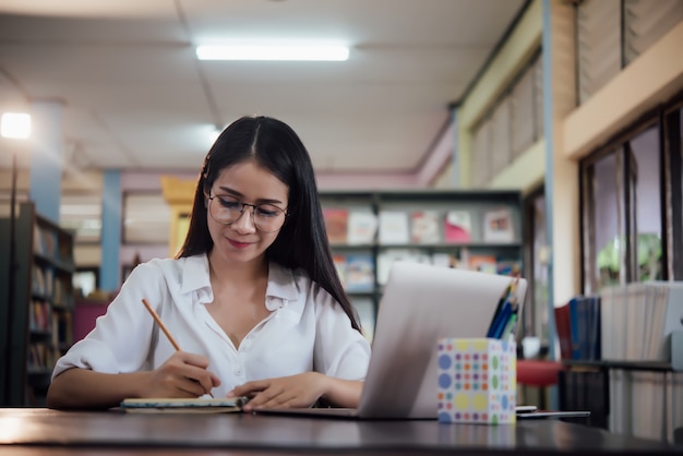  Young students learning, library bookshelves