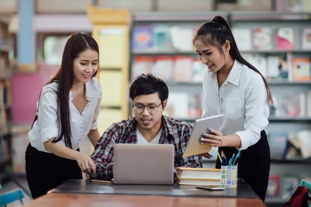  Young students learning, library bookshelves