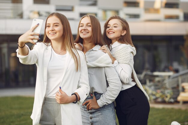 Young students on a student campus with a phone