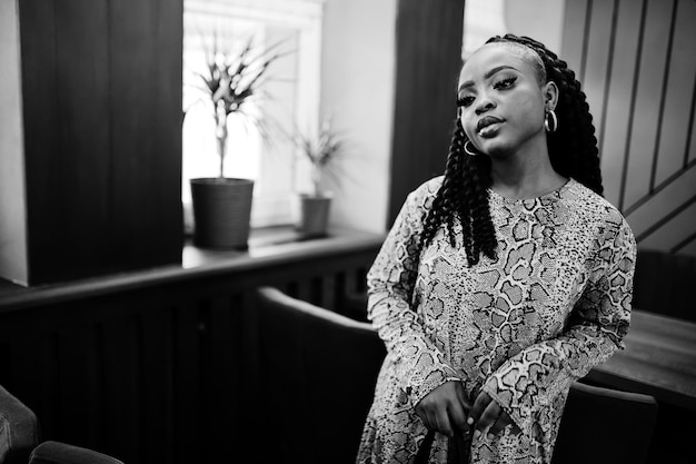 Young stylish african american woman pose at cafe