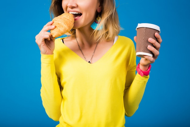 Free photo young stylish attractive woman in yellow blouse on blue