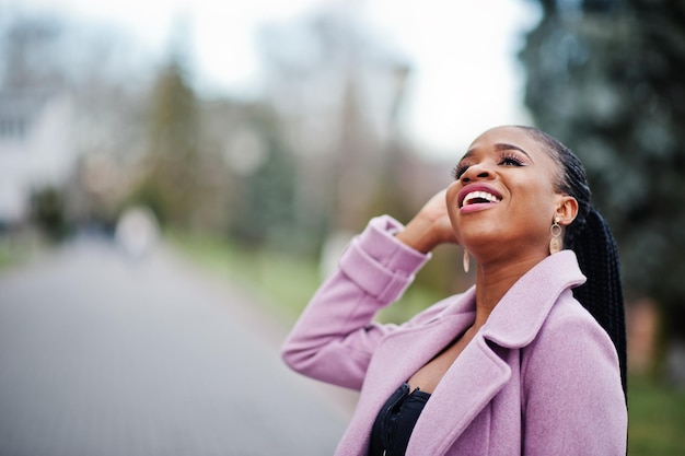 Young stylish beautiful african american woman in street wearing fashion outfit coat