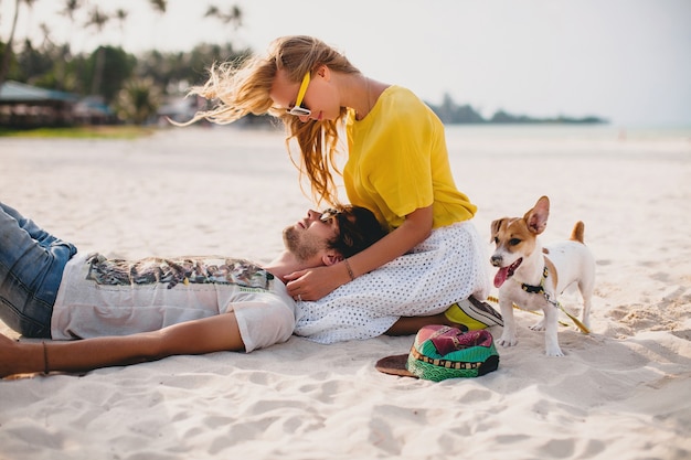 Young stylish hipster couple in love on tropical beach during vacation