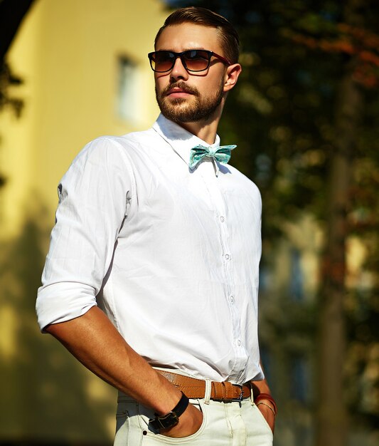 Young stylish sexy handsome model man in casual cloth lifestyle in the street in glasses