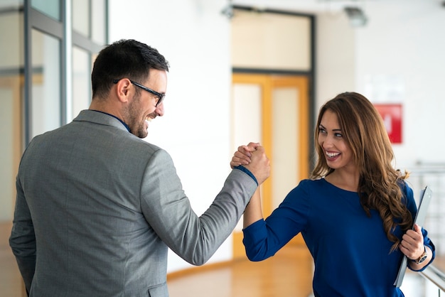 Free photo young successful business people greeting in company's office