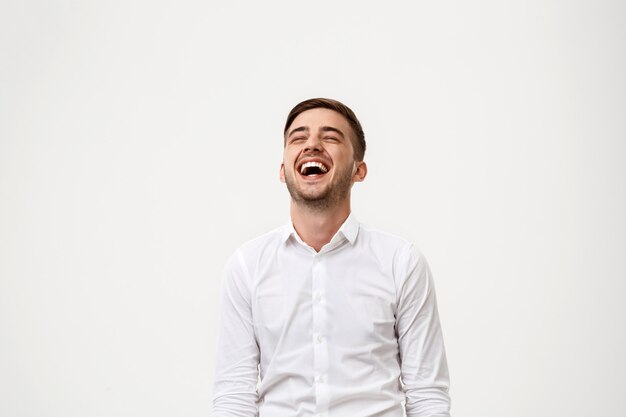 Young successful businessman smiling, laughing.