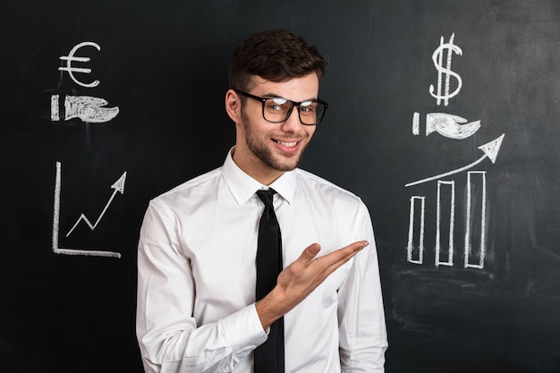 Young successful man in white shirt presenting new financial project