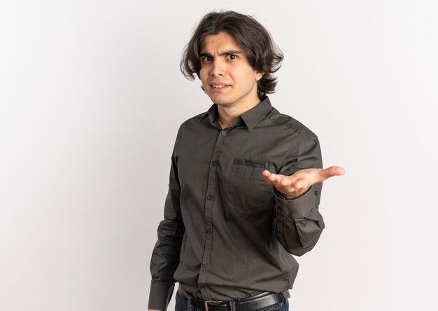 Young surprised handsome caucasian man looks and points at camera isolated on white background with copy space