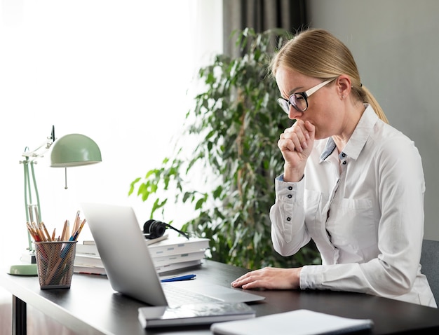 Young teacher doing her classes online and coughing