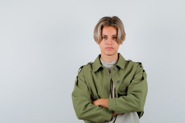 Young teen boy with arms folded in t-shirt