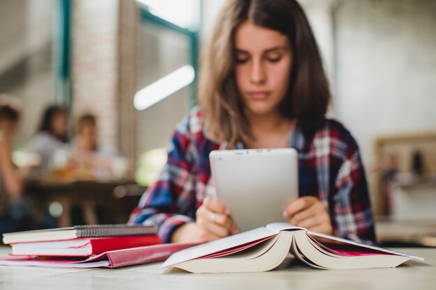 Young teen with tablet studying