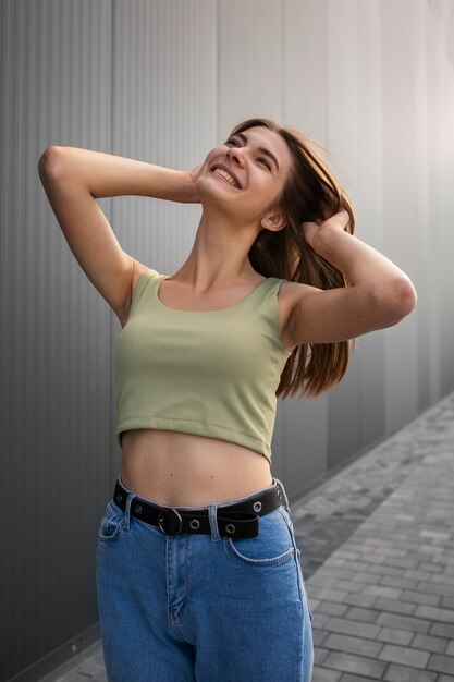 Young teenage girl recording reels of herself outdoors for social media