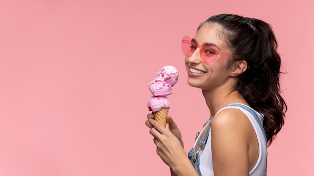 Young teenage girl with sunglasses eating an ice cream