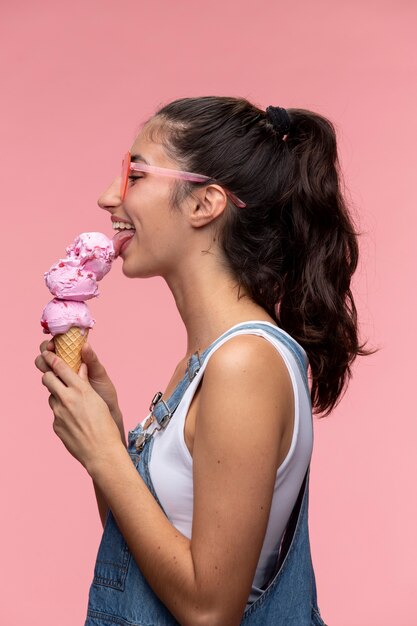 Young teenage girl with sunglasses eating an ice cream