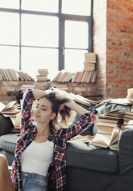 Free Photo young teenager girl reading a book at home