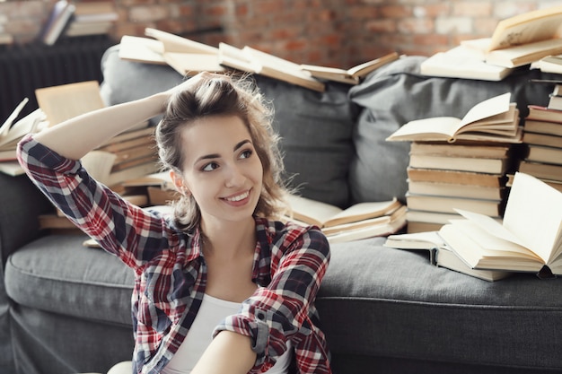 Free photo young teenager girl reading a book at home