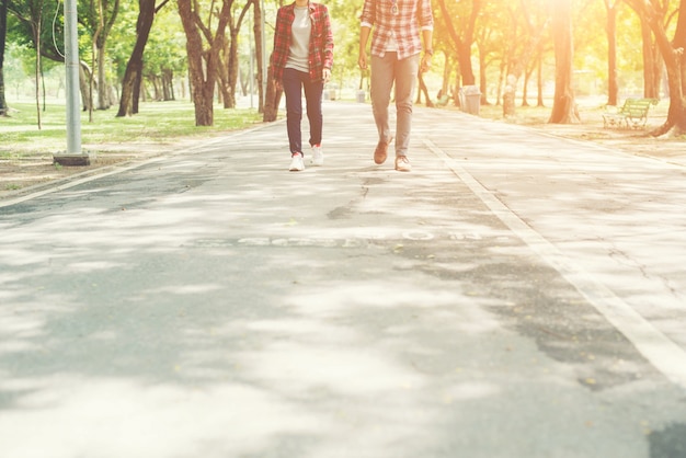 Young teenagers couple walking together in park, Relaxing holida