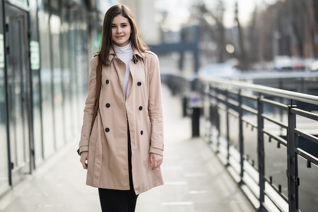 Free photo young tender brunette girl walking in the city in casual clothes