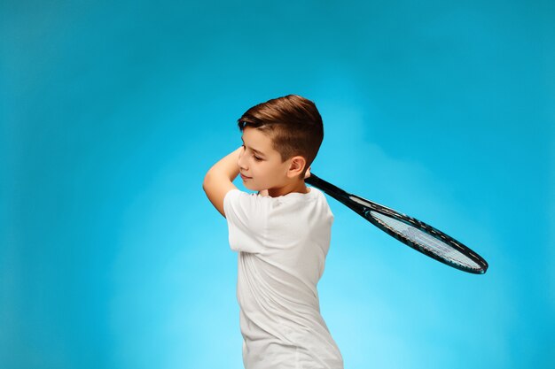 Young tennis player on blue space.