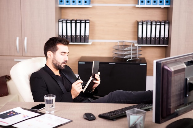 Free photo young tired businessman working in his office. businessperson in professional environment