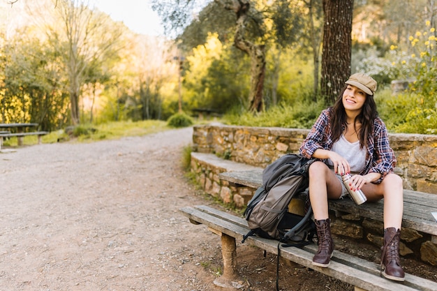 Free photo young tourist resting with thermos