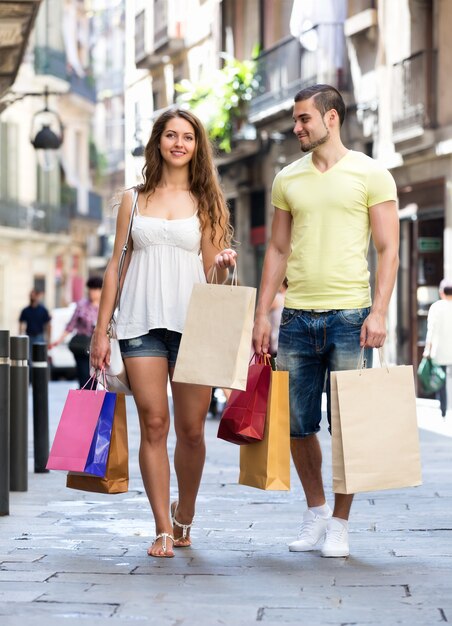 Young tourists in shopping tour