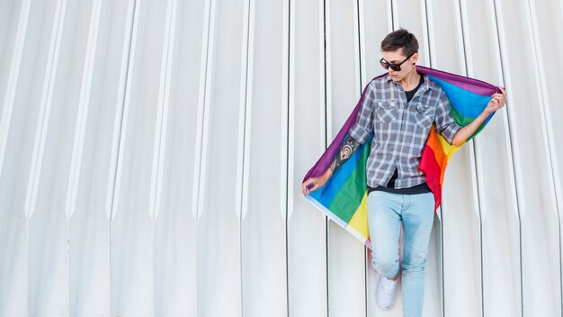 Young transgender holding LGBT flag