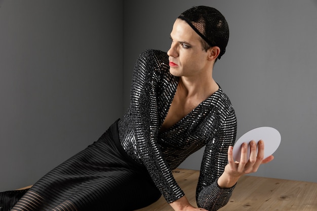 Free photo young transgender person leaning on the floor