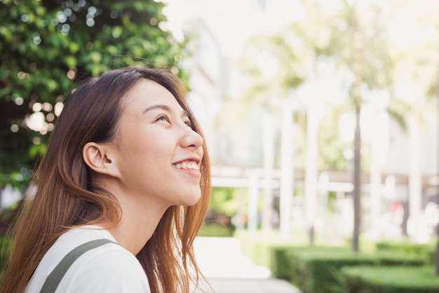 Young traveler asian woman admiring beautiful sunny narrow streets in Bangkok