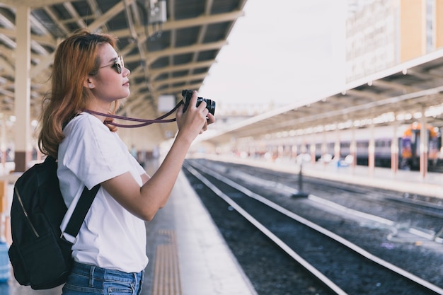 Free photo young traveler with camera on station