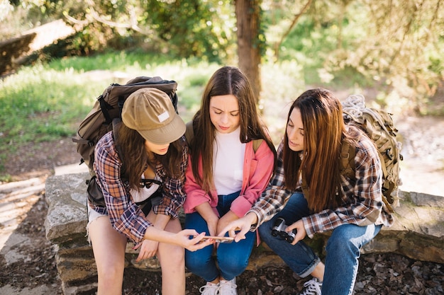 Young travellers using smartphone