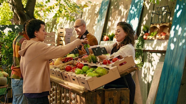 Free Photo young vendor giving free apple samples to clients