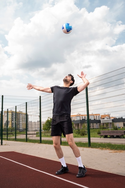 Young volleyball man player in the court