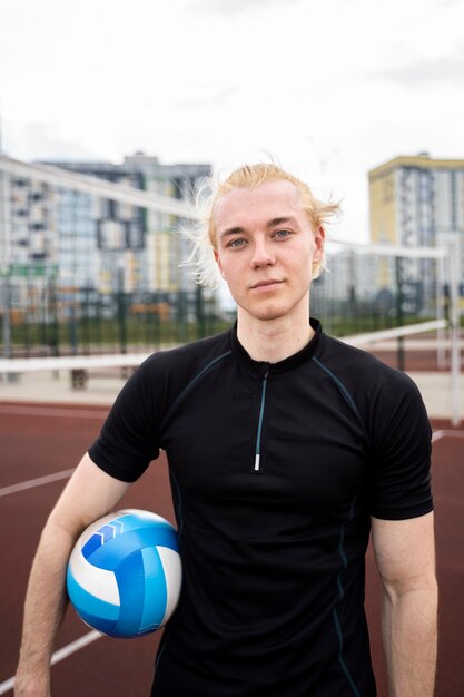 Young volleyball man player in the court