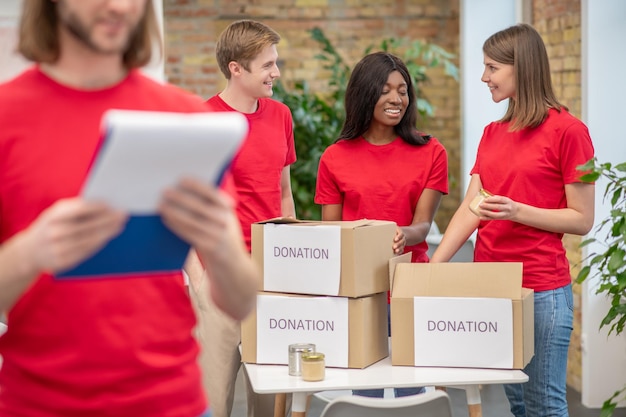 Young volunteers in red tshirts at work in a distribution point