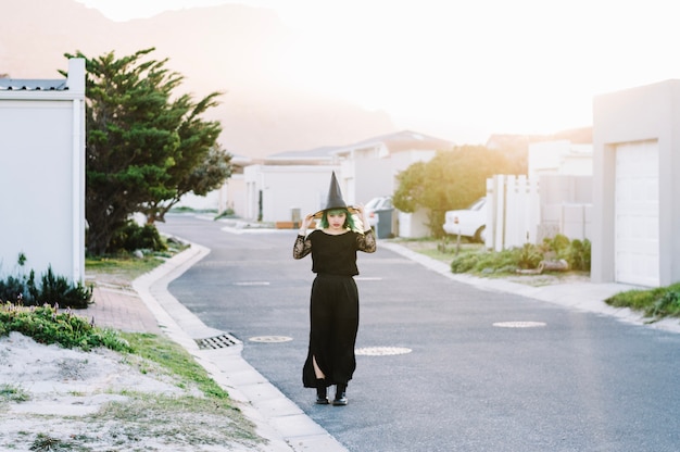 Young witch in black dress