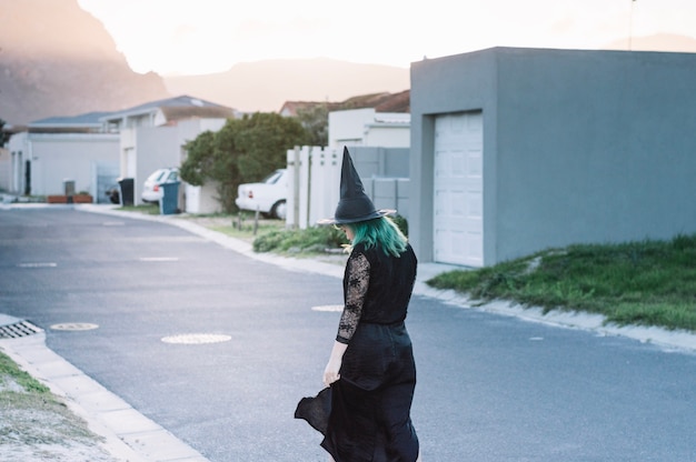 Free Photo young witch on suburban street